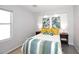 Inviting bedroom with leaf-patterned decor, bedside tables, and large window providing natural light at 3122 E Kristal Way, Phoenix, AZ 85050
