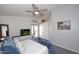 Inviting bedroom with a ceiling fan, dresser with TV, and patio access for outdoor enjoyment at 3122 E Kristal Way, Phoenix, AZ 85050
