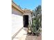 Front entryway with a black door and desert plant life along the side of the house at 3122 E Kristal Way, Phoenix, AZ 85050