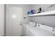 Functional laundry room featuring washer, dryer, storage shelving, and convenient access door at 3122 E Kristal Way, Phoenix, AZ 85050