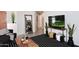 A stylish living room features a wooden coffee table, black and white rug and plants at 3122 E Kristal Way, Phoenix, AZ 85050