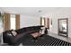 A living room features a long couch, a coffee table and a full length mirror at 3122 E Kristal Way, Phoenix, AZ 85050