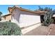 Home's exterior showcasing desert landscaping, a pathway, and neutral stucco walls at 3122 E Kristal Way, Phoenix, AZ 85050