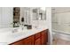 Bright bathroom featuring a double vanity with cherry cabinets and a shower/tub combo at 3644 E Del Rio St, Gilbert, AZ 85295
