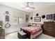 Inviting bedroom with a comfortable bed, window, and dresser at 3644 E Del Rio St, Gilbert, AZ 85295