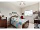 Cozy bedroom featuring a comfortable bed with colorful patchwork quilt and bright window views at 3644 E Del Rio St, Gilbert, AZ 85295