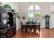 Sunlit dining room with hardwood floors, large windows, and elegant lighting at 3644 E Del Rio St, Gilbert, AZ 85295