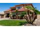 Beautifully landscaped front yard featuring vibrant green grass and mature palm trees at 3644 E Del Rio St, Gilbert, AZ 85295