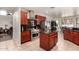 Spacious kitchen with stainless steel appliances, center island, granite counters, and access to breakfast nook at 3644 E Del Rio St, Gilbert, AZ 85295