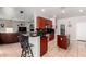 Kitchen with breakfast bar, island, tile floors and cherry wood cabinetry and open to the Gathering room at 3644 E Del Rio St, Gilbert, AZ 85295