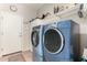 Modern laundry room featuring side-by-side washer and dryer units, and ample storage space at 3644 E Del Rio St, Gilbert, AZ 85295