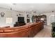 Open living room with a fireplace, media center, tile floors, and view of the outdoor patio at 3644 E Del Rio St, Gilbert, AZ 85295