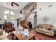 Inviting living room with a dramatic curved staircase and hardwood floors at 3644 E Del Rio St, Gilbert, AZ 85295