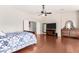 Cozy main bedroom with hardwood floors, TV, mirror, ceiling fan, and closet at 3644 E Del Rio St, Gilbert, AZ 85295