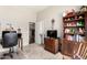 Functional office space includes desk, chair, a hutch and bookshelf unit filled with books and decorative items at 3644 E Del Rio St, Gilbert, AZ 85295