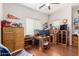 Spacious home office with hardwood floors, dual monitors, desk, and ample storage cabinets at 3644 E Del Rio St, Gilbert, AZ 85295