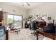 Inviting home office with a desk, rolling chair, balcony access, and bright natural light at 3644 E Del Rio St, Gilbert, AZ 85295
