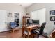 Well-lit home office featuring a wooden desk with dual monitors, hardwood floors, and a comfortable chair at 3644 E Del Rio St, Gilbert, AZ 85295