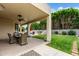 Covered patio features stylish wicker furniture and a view of the green lawn and pool area at 3644 E Del Rio St, Gilbert, AZ 85295