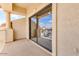 This patio features neutral stucco with large sliding glass doors, a pillar, and a view of the street at 3644 E Del Rio St, Gilbert, AZ 85295
