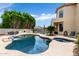 Inviting backyard featuring a pool, spa, waterfall, and seating area, perfect for outdoor entertaining at 3644 E Del Rio St, Gilbert, AZ 85295