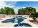 Beautiful backyard oasis featuring a pool, spa, rock waterfall, lush landscaping, and outdoor bar at 3644 E Del Rio St, Gilbert, AZ 85295