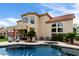 Backyard pool and patio area showcasing a two-story home, landscaping, and space for relaxation at 3644 E Del Rio St, Gilbert, AZ 85295