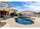 Inviting backyard pool with a soothing waterfall feature, complemented by lush landscaping at 3644 E Del Rio St, Gilbert, AZ 85295