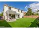 Spacious backyard featuring artificial turf, a covered patio, and block wall, perfect for outdoor activities and low maintenance at 4135 E Waterman Ct, Gilbert, AZ 85297