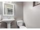 Bathroom featuring a white sink, a toilet, and neutral tones, with a mirror hanging above the sink at 4135 E Waterman Ct, Gilbert, AZ 85297