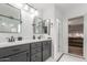 Modern bathroom with a double vanity, black cabinets, and stylish mirrors, offering a serene and functional space at 4135 E Waterman Ct, Gilbert, AZ 85297