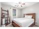 Comfortable bedroom features wood furniture, ceiling fan, and natural light, creating a warm and inviting space at 4135 E Waterman Ct, Gilbert, AZ 85297