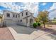 Charming two-story home with a well-manicured front yard and spacious driveway at 4135 E Waterman Ct, Gilbert, AZ 85297