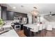 Kitchen with white countertops, stainless steel appliances, and modern fixtures, flowing into the living room at 4135 E Waterman Ct, Gilbert, AZ 85297
