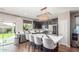 Modern kitchen featuring stainless steel appliances, a center island with seating, and granite countertops at 4135 E Waterman Ct, Gilbert, AZ 85297