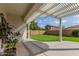 A covered patio overlooking a well-maintained yard with artificial turf, creating an ideal space for outdoor relaxation at 4135 E Waterman Ct, Gilbert, AZ 85297