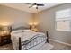 Cozy bedroom with comfortable queen bed, lamps and bedside tables with a ceiling fan at 41413 W James Ln, Maricopa, AZ 85138