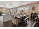 Dining area featuring a modern chandelier and open access to backyard patio and pool at 41413 W James Ln, Maricopa, AZ 85138