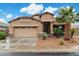 Beautiful home featuring a two-car garage, neutral stucco, desert landscaping and a gorgeous palm tree at 41413 W James Ln, Maricopa, AZ 85138
