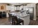 Spacious kitchen featuring white cabinets, granite countertops and stainless steel appliances at 41413 W James Ln, Maricopa, AZ 85138
