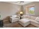 Bright living room with comfortable white furniture and a ceiling fan for a modern feel at 41413 W James Ln, Maricopa, AZ 85138