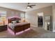 Spacious main bedroom featuring a walk-in closet, ceiling fan and ambient lighting at 41413 W James Ln, Maricopa, AZ 85138