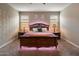 Well lit main bedroom with ambient lighting, carpet floors and neutral paint at 41413 W James Ln, Maricopa, AZ 85138