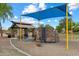 Community playground area featuring climbing structure and covered picnic tables at 41413 W James Ln, Maricopa, AZ 85138