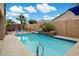 Sparkling pool in private backyard with lush landscaping and beautiful blue tiled trim at 41413 W James Ln, Maricopa, AZ 85138