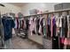 Organized walk-in closet with ample storage space for clothing and accessories at 41413 W James Ln, Maricopa, AZ 85138