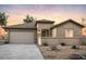 Charming single-story home with a neutral color scheme, tile roof, well maintained desert landscaping, and a two car garage at 42945 W Palo Abeto Dr, Maricopa, AZ 85138