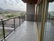 Enjoy city views from this condo's balcony, featuring a metal railing and glass doors to the interior at 4750 N Central Ave # A10, Phoenix, AZ 85012