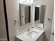 Bathroom featuring a modern vanity with a white countertop and framed mirror with stylish light fixture at 4750 N Central Ave # A10, Phoenix, AZ 85012
