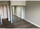 Bedroom featuring a mirrored closet and neutral wall paint with wood-look floors at 4750 N Central Ave # A10, Phoenix, AZ 85012
